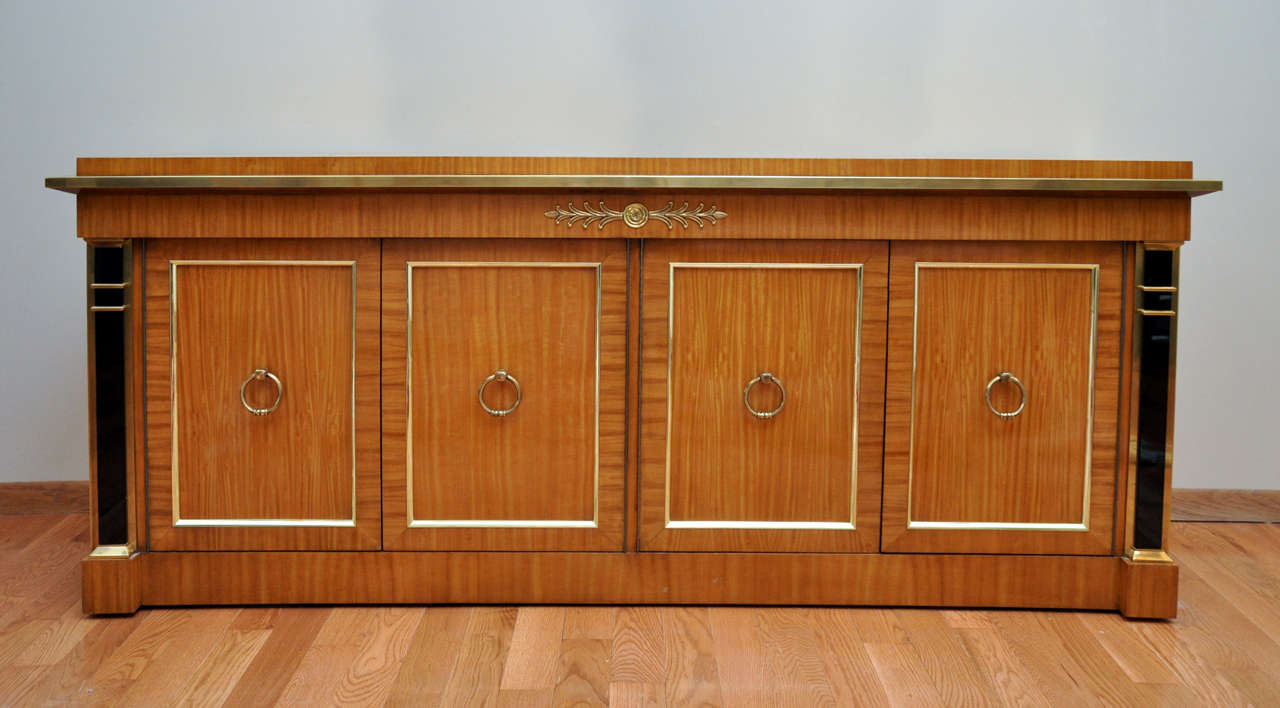 Rare Mastercraft credenza circa the 1970s.  Matched grain satinwood.  Ring hardware pilaster columns.  brass details.  The credenza is in exceptional excellent original condition.