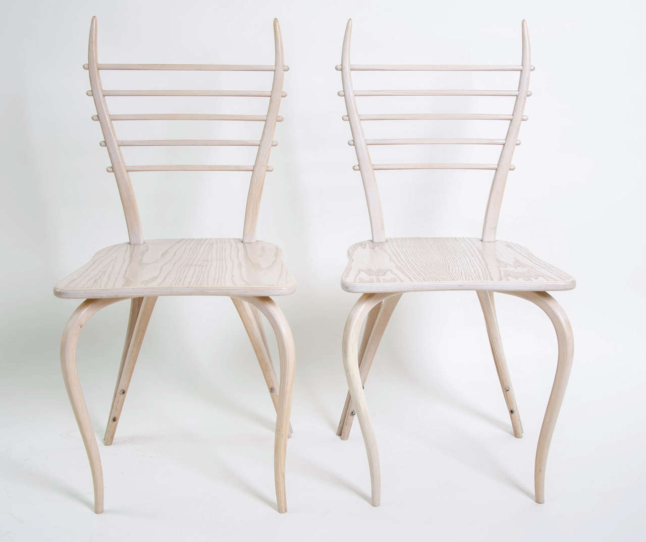 A pair of  Lyre chairs by the acclaimed designers produced by Furniture in 1989. This model in bent birch wood and bronze fixtures is part of the Design collection at the Pompidou Center in Paris where they were shown as part of the major 1997