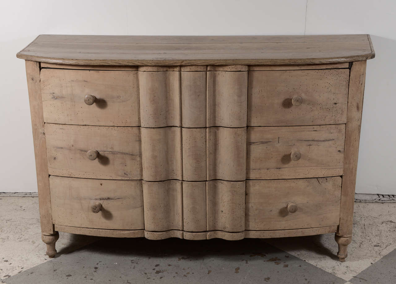Simple and beautiful 18th century bleached cherry chest with wood knobs, unusual curved form.