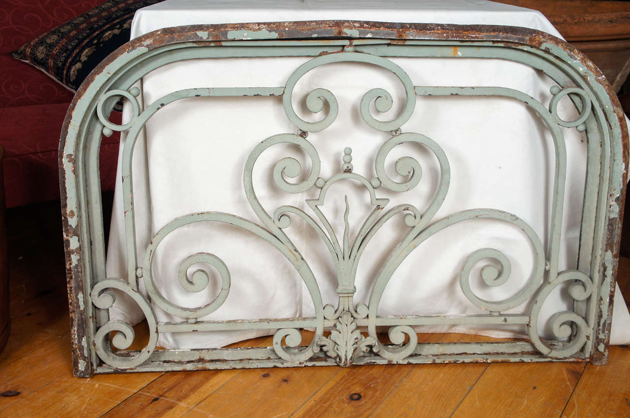 Iron transom, or overdoor Philadelphia Pa, 1900, salvaged by Kamelot Auctions, PA, with beautiful scroll decoration and central fleur de lis. In iron frame.