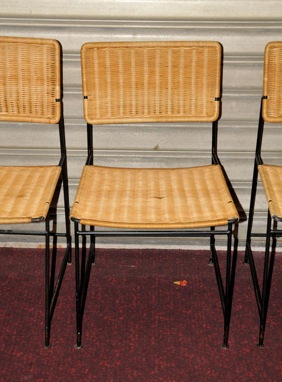 Set of ten 1950's chairs in black lacquered metal and rattan. Some traces on the metal. Rattan in good condition. Good condition. Normal wear consistent with age and use.