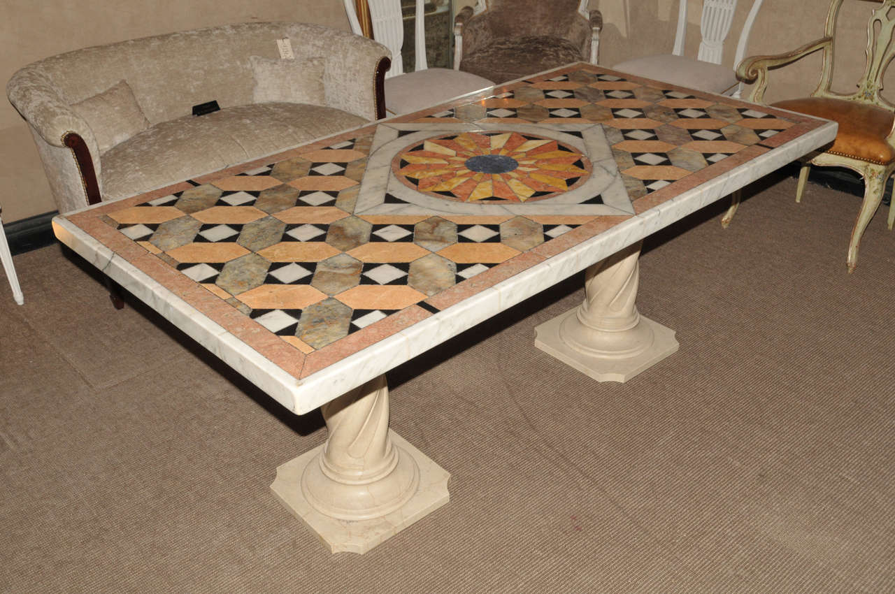 Large 1970's marble marquetry italian table. Carved white marble feet. Good condition. Normal wear consistent with age and use.