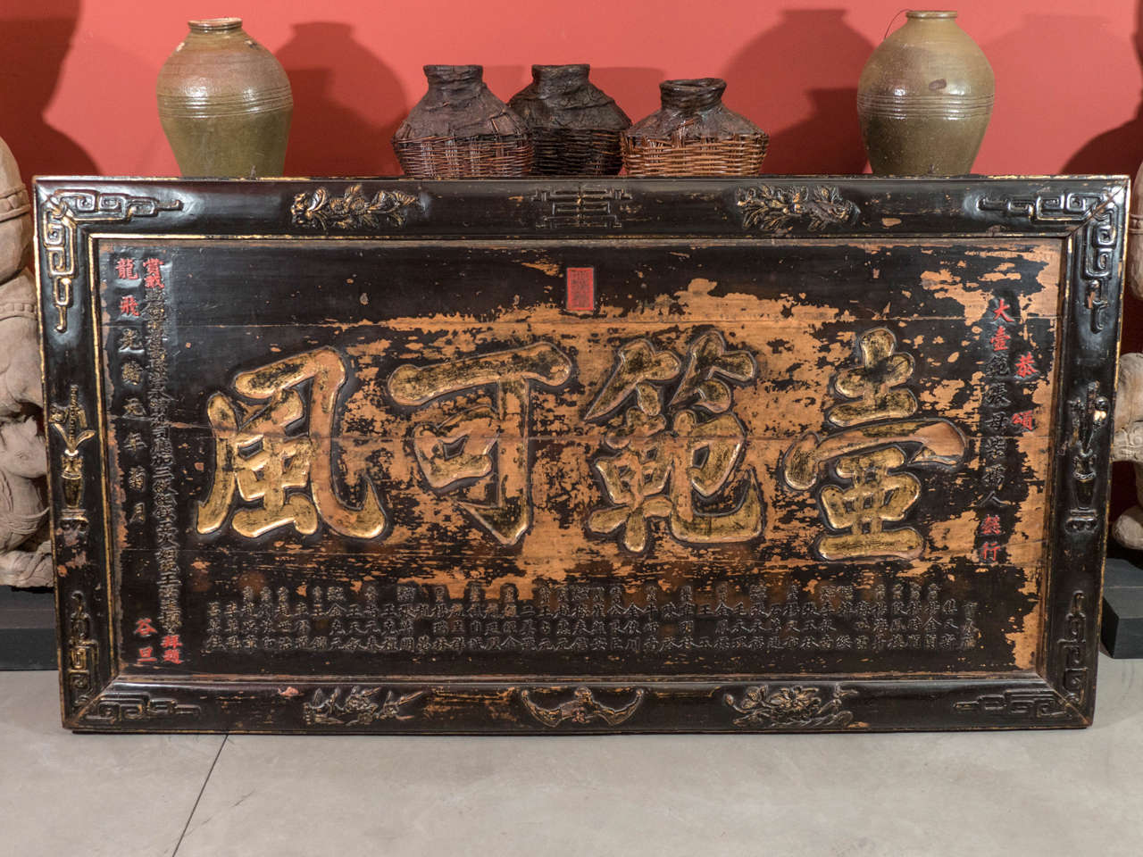 An elaborate and intricately carved master of tea ceremony sign inscribed with the names of the master and his students, as well as the date. Beautiful gold lacquer highlights the large central characters. Detailed carvings appear on the frame of