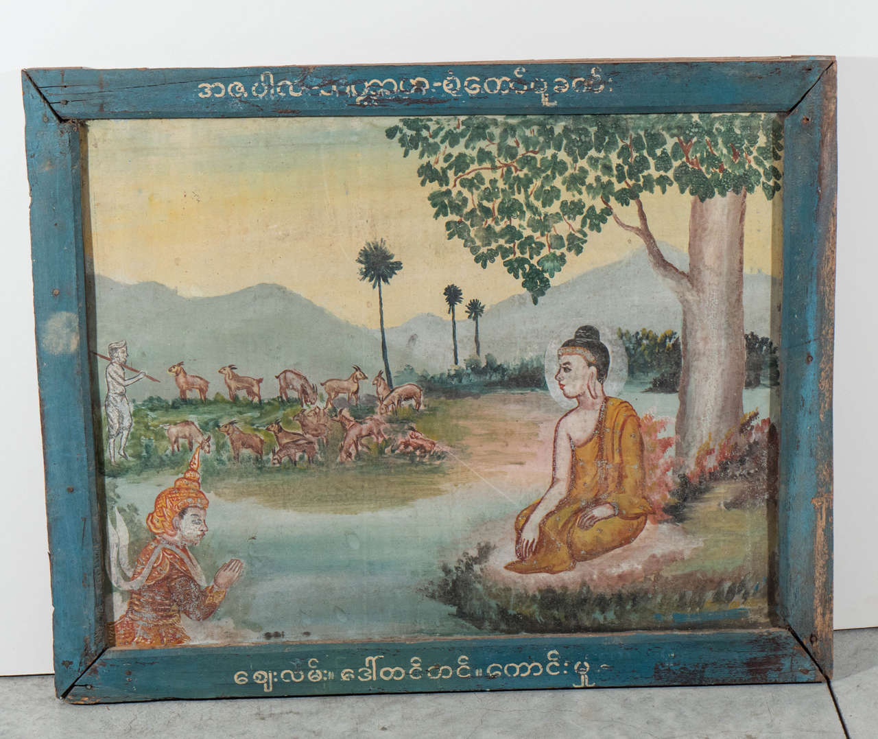 An unusual Burmese Buddha story painted on tin. This temple painting is offered in it's original frame, which has Burmese script at the top and bottom of the painting.  A wonderfully contemplative and spiritual piece. Burma, c.1930's.
P360