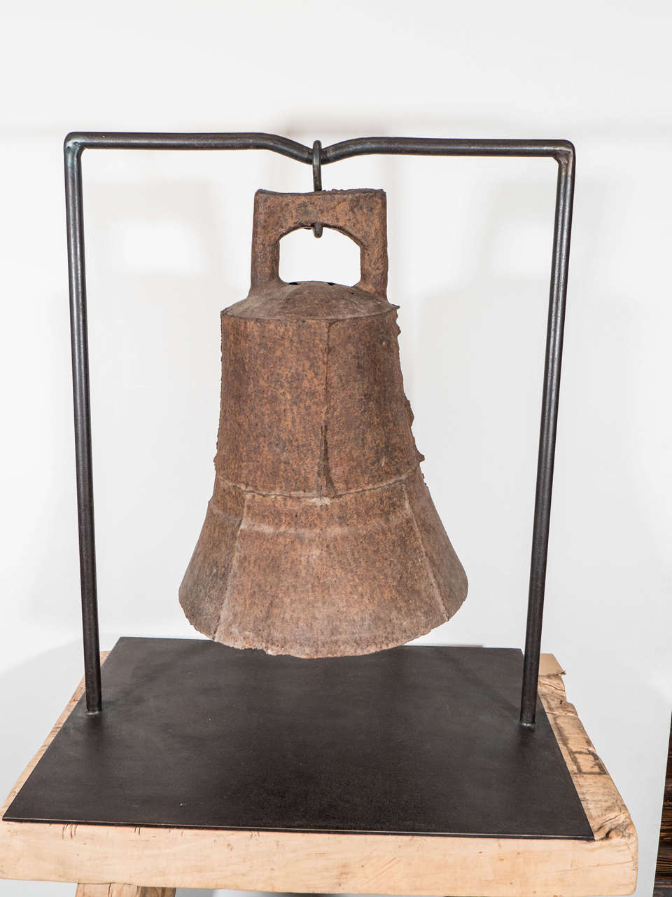 An unusually large and striking cast iron temple bell with custom iron stand. Beautifully patinated from years of use, this piece virtually emanates age and spirituality.   The rough casting markings add visual interest and authenticity to this