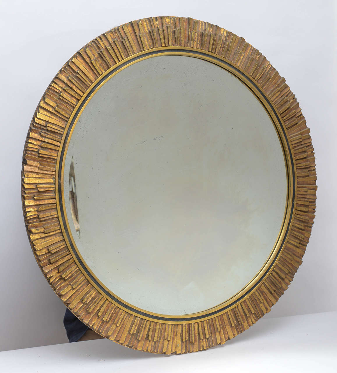 Italian Sunburst mirror made of inlaid hand-cut pieces of gilded wood.
Mirror itself is beveled and contains foxing indicating its vintage age.
