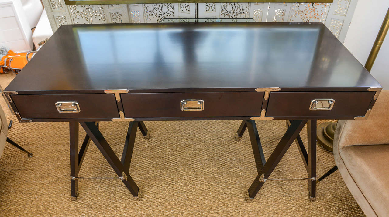 Very rich looking Campaign desk in stunning deep and rich coffee brown stain. Decorated with chromed hardware around the drawers and trestle legs.