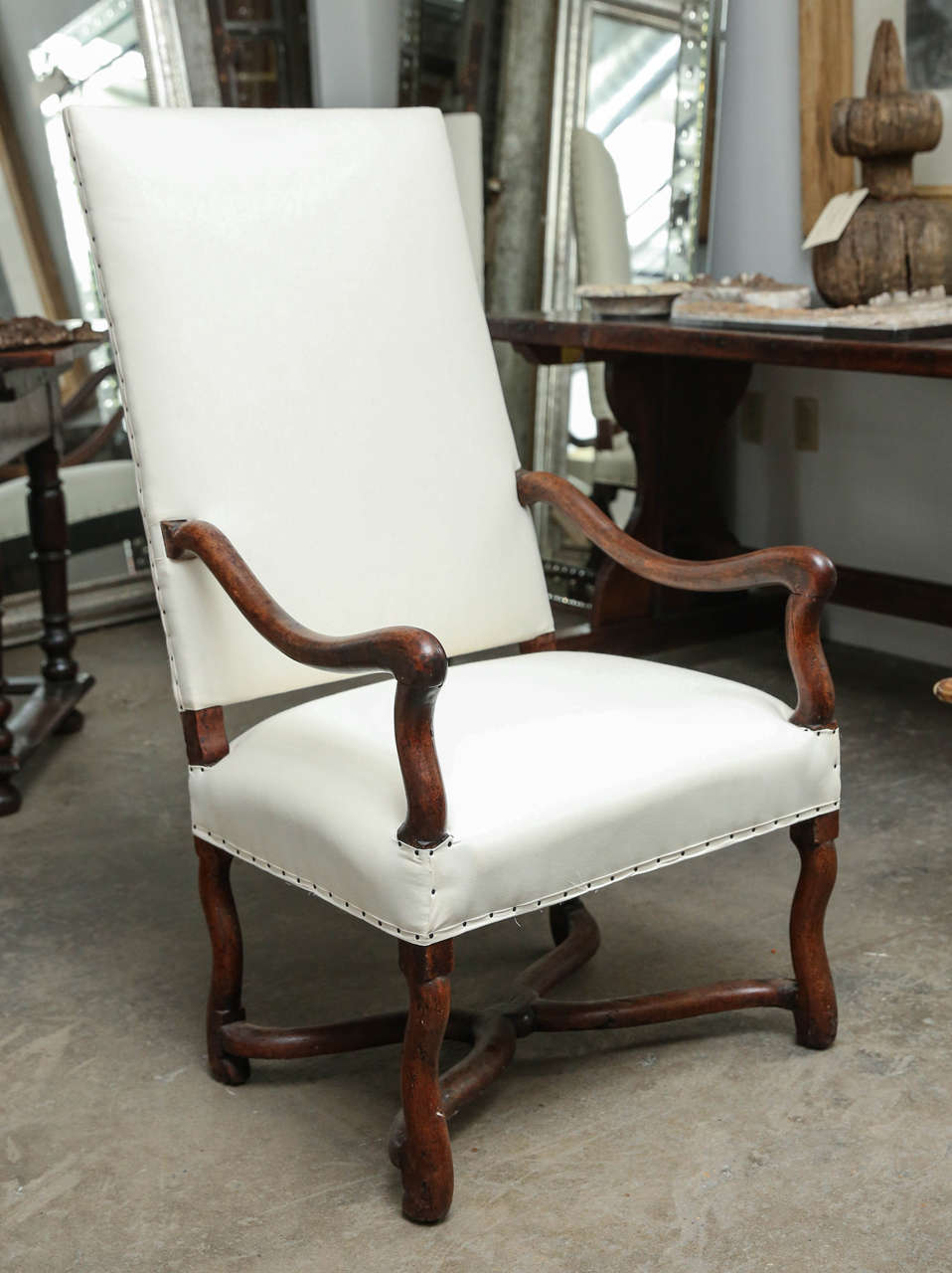 18th century Walnut Os De Moutan upholstered Louis XIII chair with arms. Beautiful stretchers and patina.