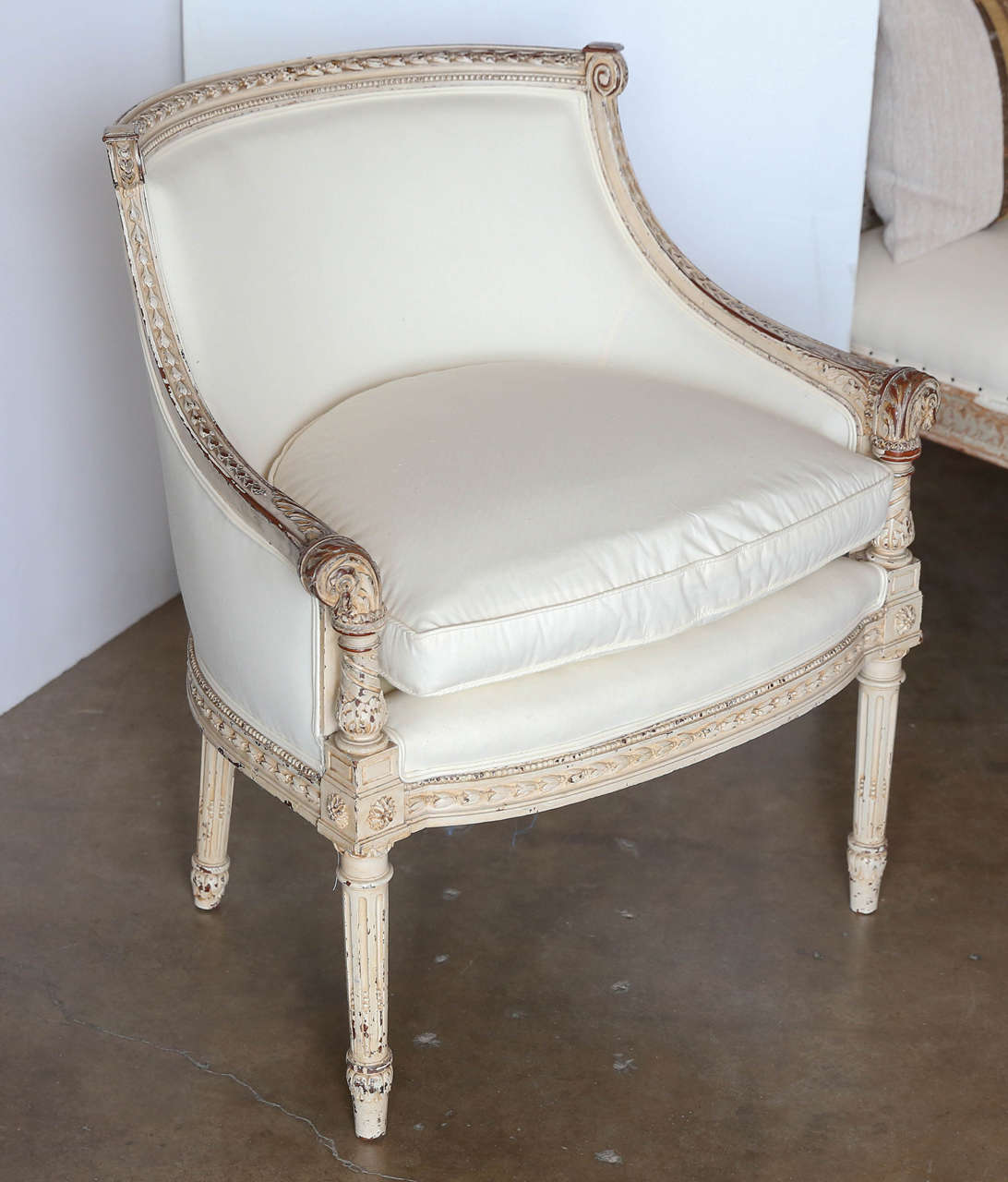 Pair of Louis XVI Barrel chairs with original paint and detailed carving.
