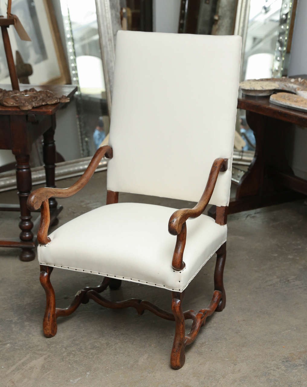 18th century walnut Os de Mouton upholstered Louis XIII chair with arms. Beautiful patina.