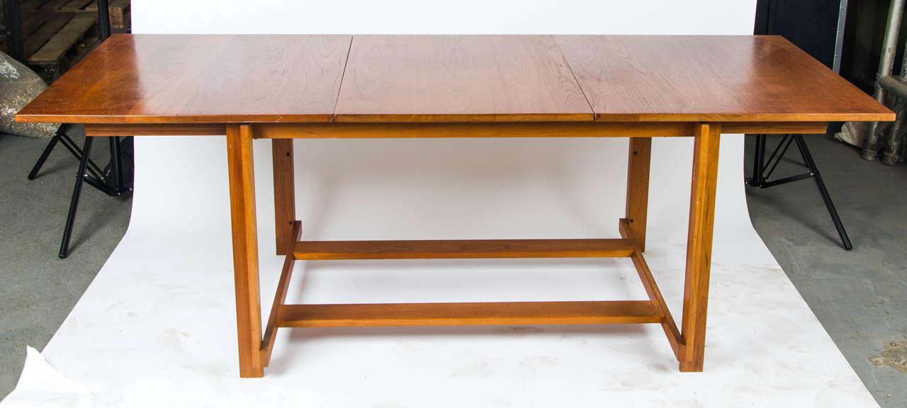 An unusual 1960s dining table by the Danish manufacturers France & Sons. Beautifully made in teak, the table extends for comfortable dining for six - eight covers. Full extension 203cm (L) x 86cm (W) x 70cm (H).