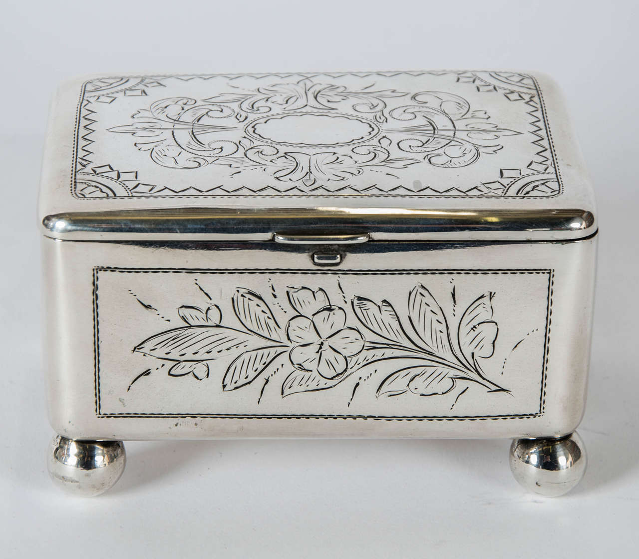 Judaica silver, a rare imperial Russian silver and silver gilt spice or sugar box, made during the Russian occupation of Poland. Hand engraved with floral and scroll motifs to all sides and fitted with a push button to open the lid with the interior