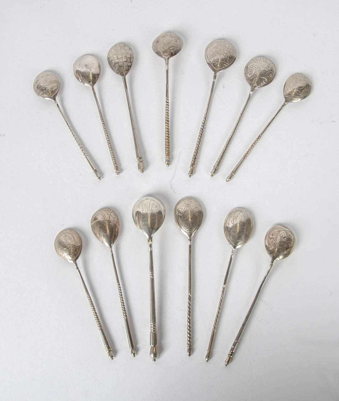 A collection of 13 Russian Imperial silver spoons all hallmarked with various town, city and makers marks, the spoons date between 1874-1889.
All the spoons have different decorations to the back of their bowls with the highlight being a steam