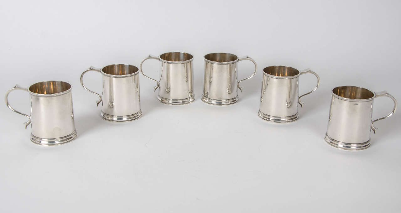A set of six silver half pint tankards in George III style made in Sheffield 1938/9 by Roberts and Belk. Each tankard is 8.5 cm high and the total weight for the six is 1353 grams.