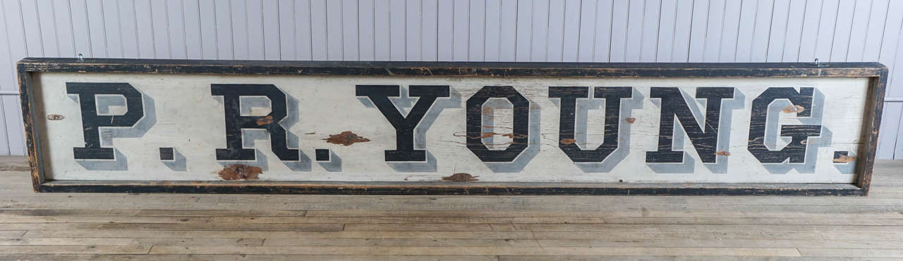 P. R. Young - bold graphics - black lettering with gray shadowing on white field - dovetailed black framing.