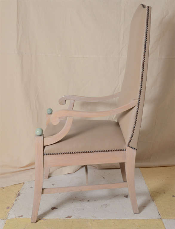 Lime Oak with turquoise stained ball finals terminating the front legs. Upholstered in a taupe nailheaded leather