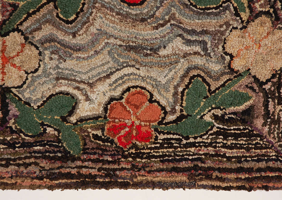 Fantastic geometric and floral hand hooked 19thc mounted rug ready for hanging. This wonderful floral hand hooked rug has a very geometric striped background and very folky flowers in a vine formation .The condition is very good minor wear in the
