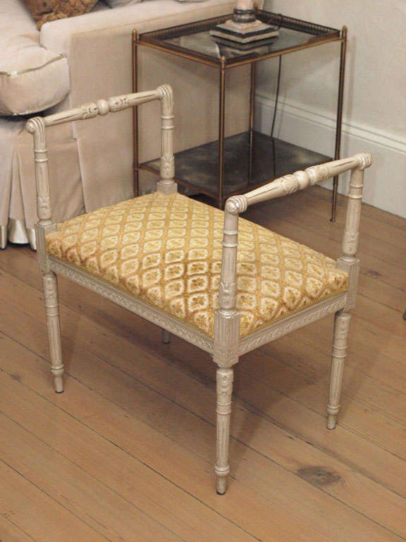 Louis XVI style bench upholstered in a yellow patterned velvet painted off-white with distressing.