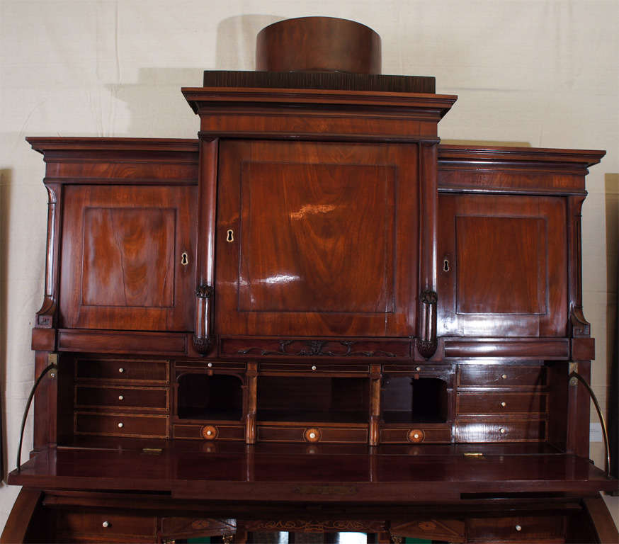 Period Danish Biedermeier Secretary bureau in mahogany with satinwood trim with cylinder desk, inside small drawers with bones pulls and a recessed ornamental 'templed' secret drawer. An upper level pull-out desk also reveals small drawers and