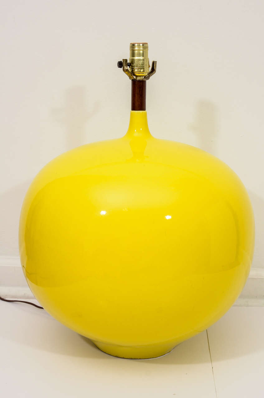 Large-scale ceramic lamp in a wonderful lemony-yellow glaze with teak detail to neck. 22