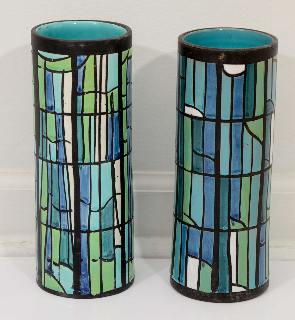 Italian ceramic vase pair in breezy blues and greens, accented with a solid aqua glaze to interior. Signed Bitossi for Raymor.