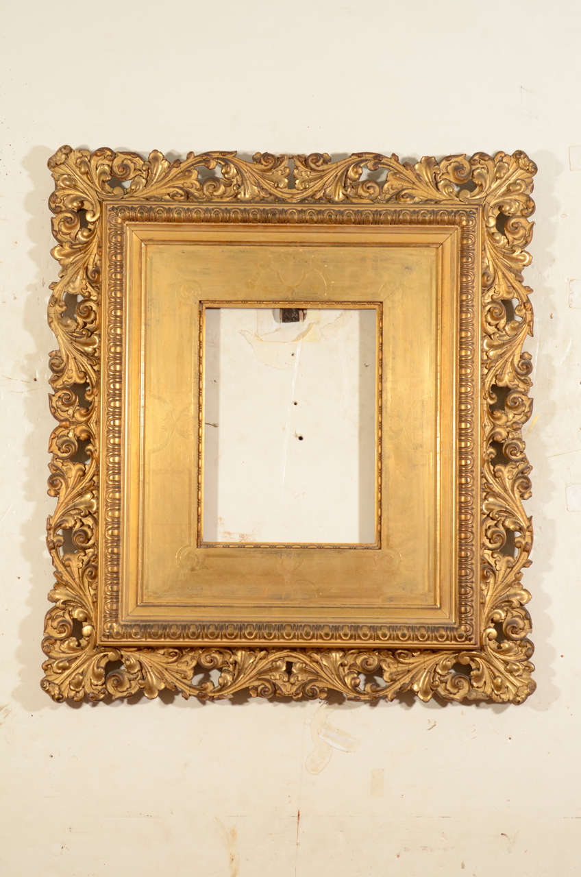 American gilded applied composition on wood with pierced scrolling foliate outer moulding, wide panel liner delicately incised with Renaissance Revival decoration.  Circa 1890.
Exterior dimensions: 23 x 20 inches
Rabbet dimensions: 10 1/8 x 7 1/2