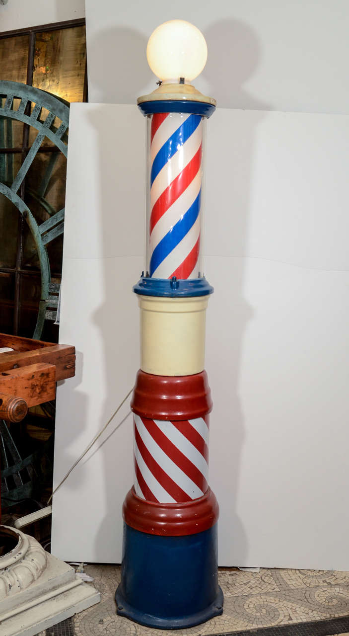 This is a very rare full size circa 1920s original cast iron barber pole. Enclosed portion lights up and rotates. Globe on top is a replica plastic. Working but motor grinds slightly when rotating. Original paint. This can be seen at our 5 East 16th
