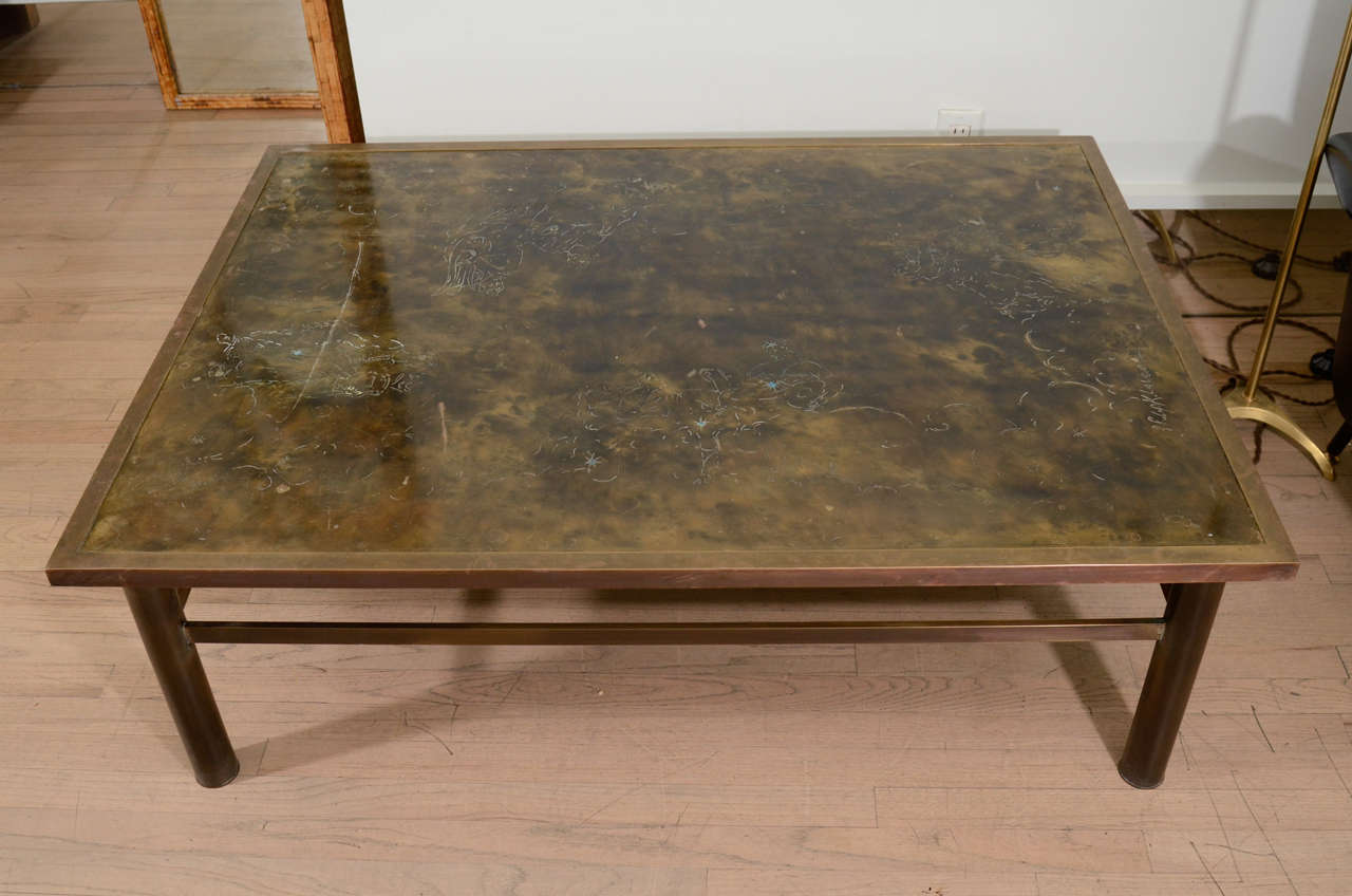 Bronze table by P&K Laverne, etched with zodiac figures/ Stands on bronze tubular legs.
