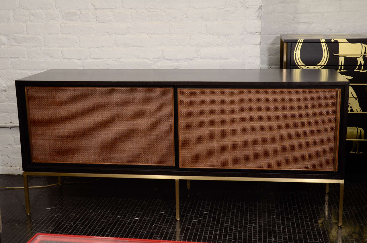 Re: 379 ebonized walnut credenza with cane front doors, brass handles and base.