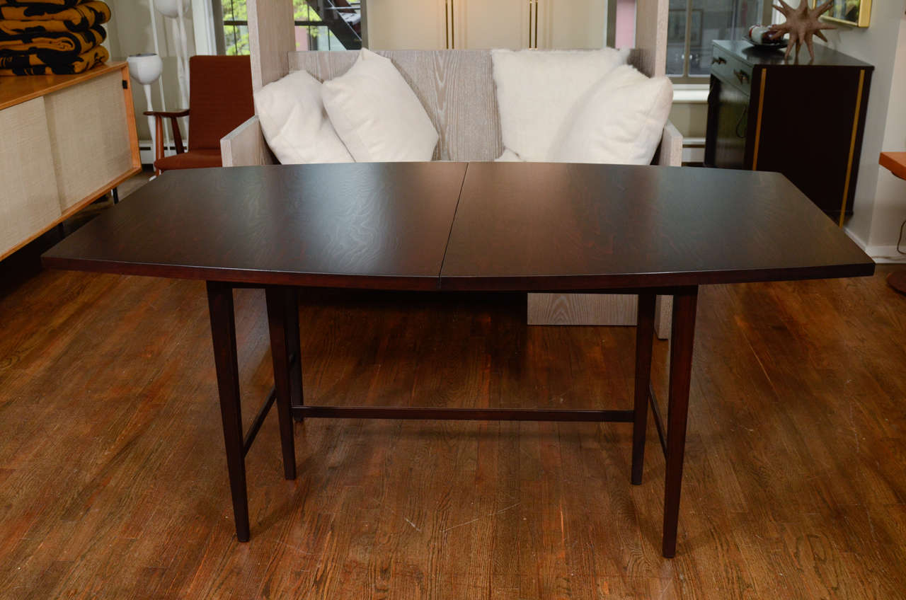 Ebonized Paul McCobb dining table with one leaf.  There are 6 coordinating caned backed chairs available separately-1950′s.