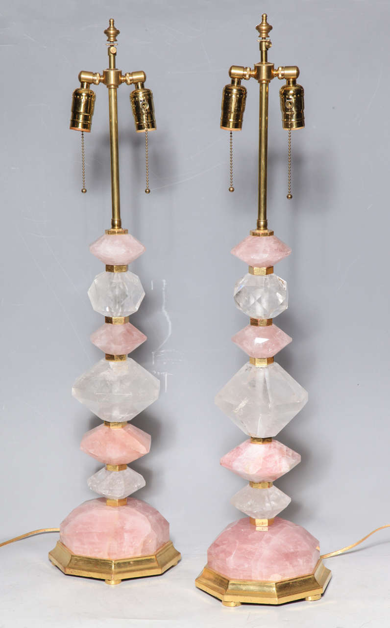 A fine pair of Bagues style geometric design cut and hand polished rose quartz and clear rock crystal table lamps on gilt wood bases, 20th century. Height including electrical fittings 33 inches.