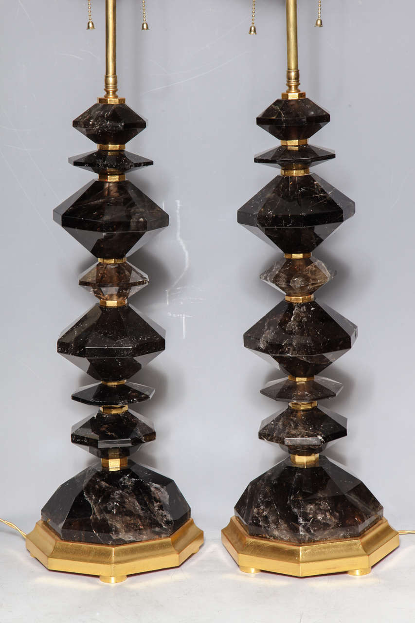 A fine pair of octagonal cut and hand polished smokey rock crystal quartz table lamps on gilt wood bases, 20th century. Height overall with electrical is 37 inches.