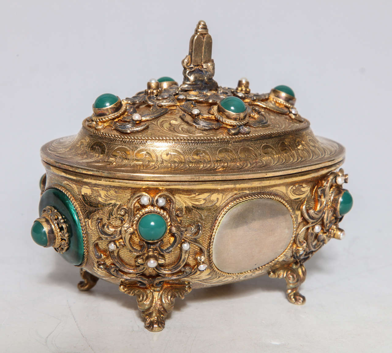 Viennese Judaica Silver Etrog Box exquisitely hand engraved with silver marks on bottom. The symbol of the torah presides on the lid overlooking mother-of-pearl accents inlaid in the curving arabesques. Green enamel and possibly jade cabochon