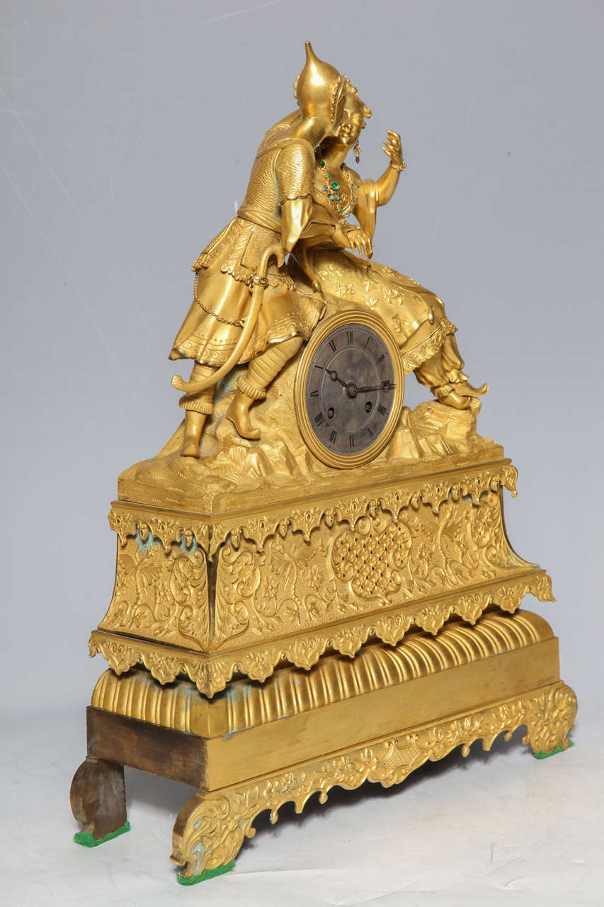 19th c. French Gilt Dore Bronze Chinoiserie Clock possibly made for the Chinese market. The intricately dressed figures are highly detailed with two toned gilding in both matte and varnished gold. The Lady is adorned in faux-emeralds, which gleam
