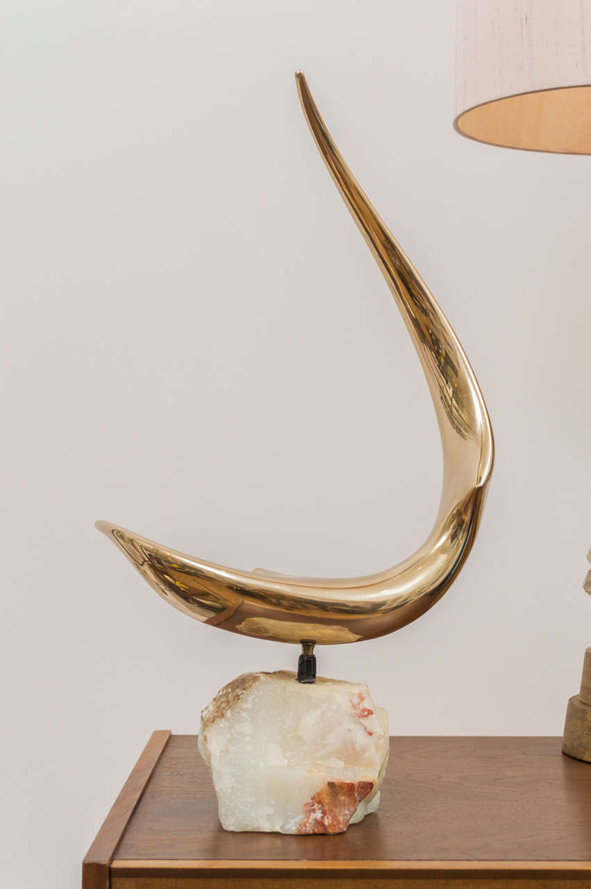 Signed and dated Lou Pierson  sculpture mounted on a stone base.