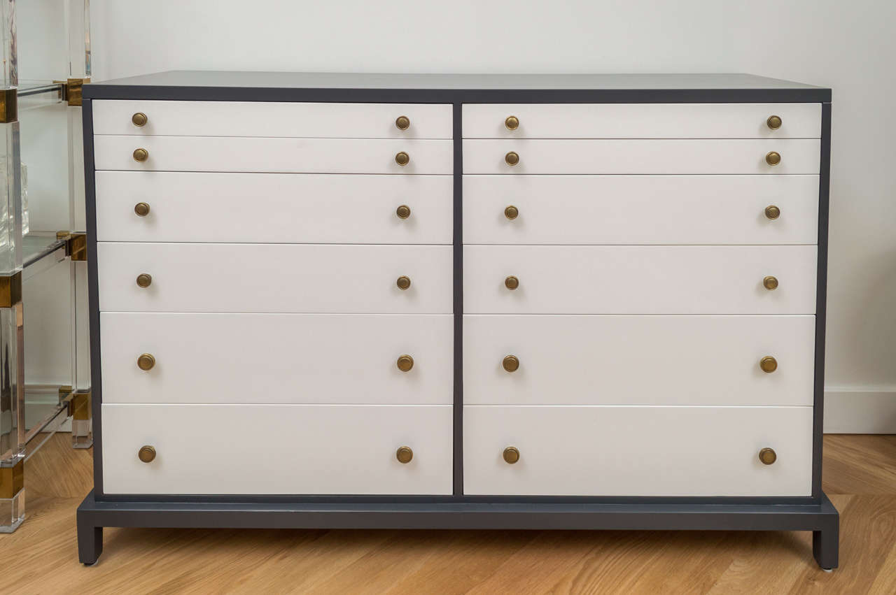 Impressive 16 drawer lacquered Robsjohn chest.
Two tone lacquer finish with brass hardware.