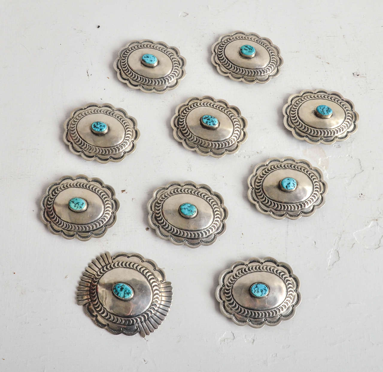 Ten silver and turquoise concho belt components. Native American. All pieces are the same, except for larger piece used as belt buckle. Measures: Pieces: 3 1/8" x 2 5/8"; buckle: 3 1/2" x 3".