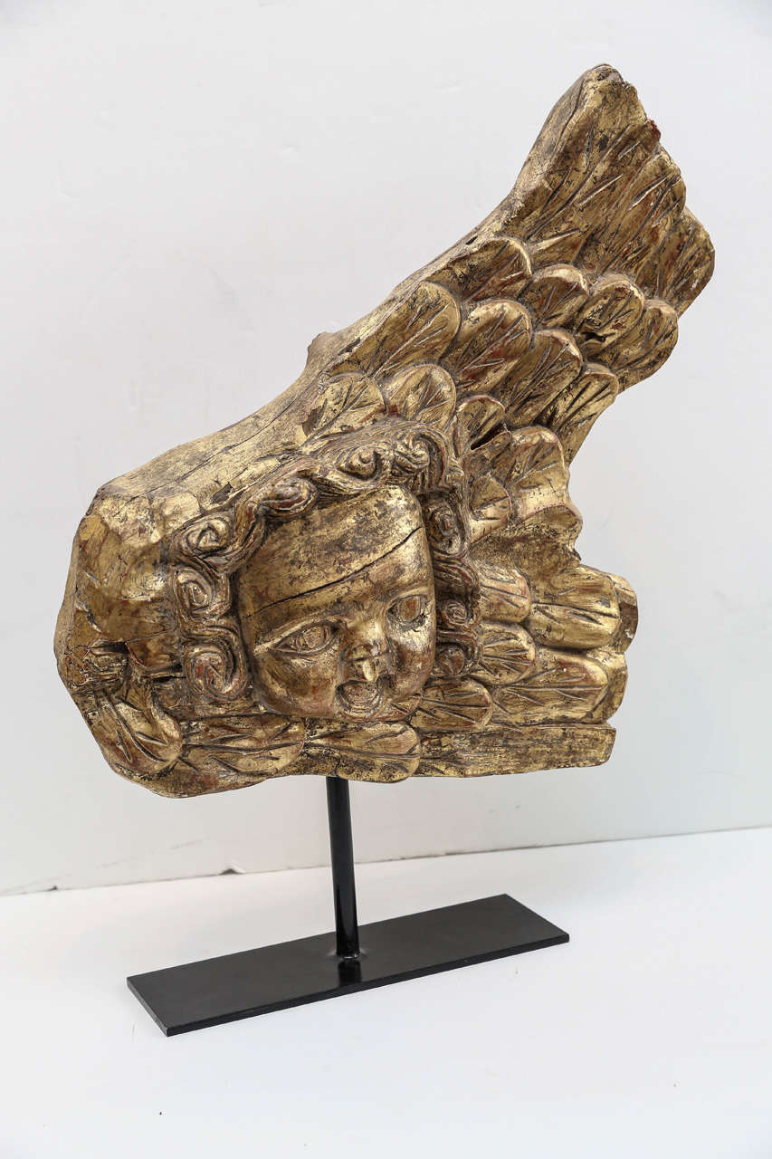 19th century Portuguese gilded angel carving mounted on an iron base.