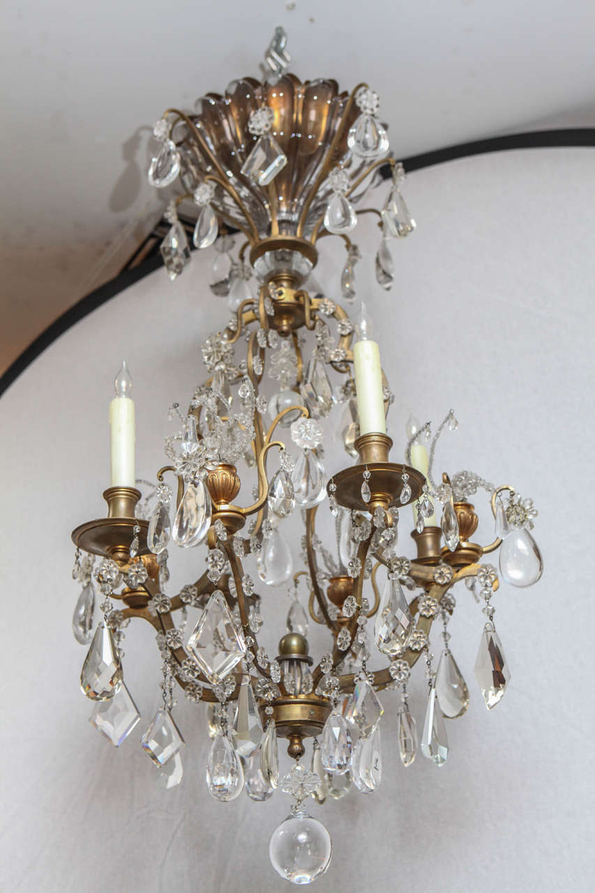 Very fine 1900's French Bagues Dore Bronze and Crystal Chandelier with 4 lights.  A beautiful crystal canopy adorns the top. Newly wired.