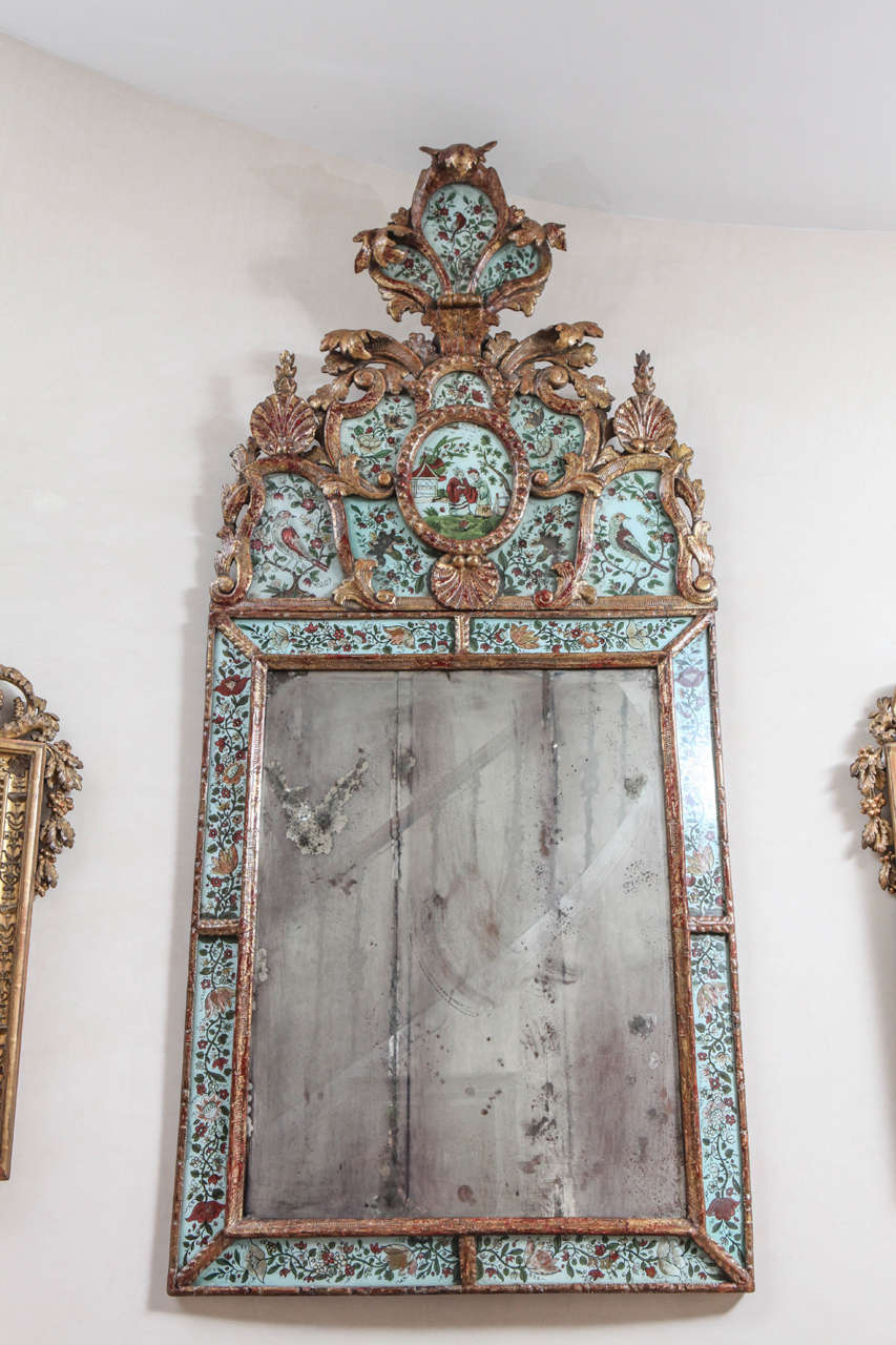 Colorful and rare 19th c. Italian Giltwood Reverse Painted Glass Mirror with Painted Chinoiserie motif. 
The Mirror is two pieces, a crown top and the mirror below it.