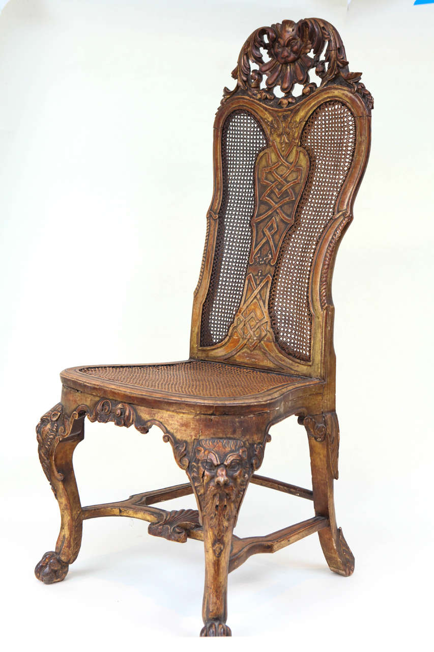 Single 19th c. English Carved Giltwood Queen Anne Style Side Chair with Cane back and seat.  Carved Lion Head Motif and Paw Feet.