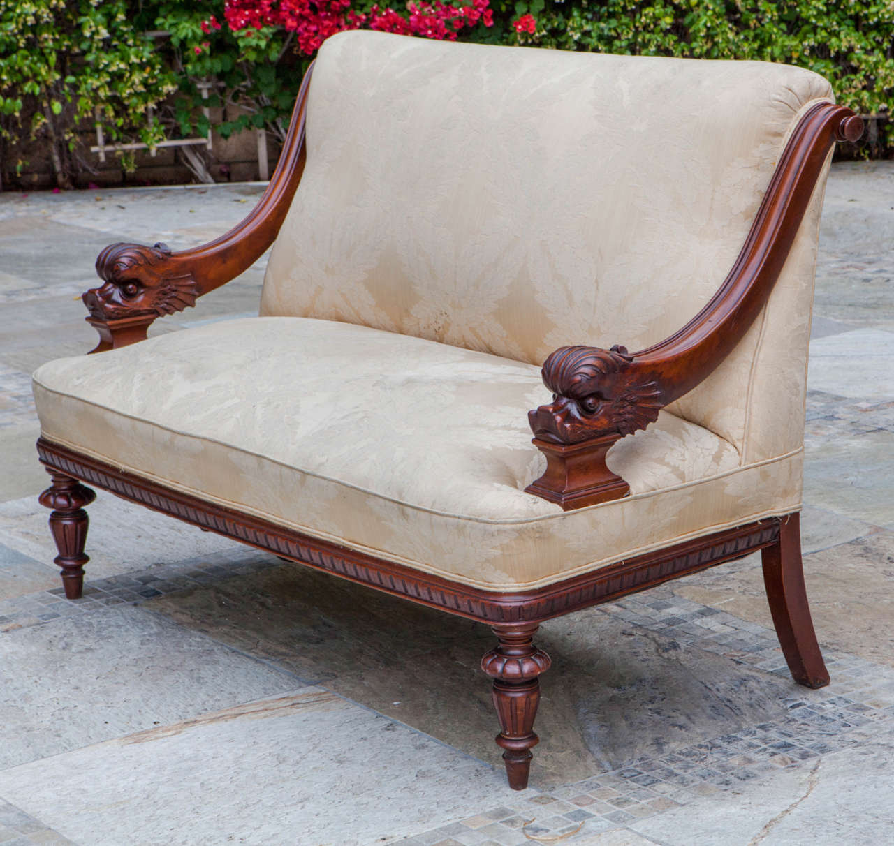 19th century American finely carved mahogany upholstered settee with dolphin arms.