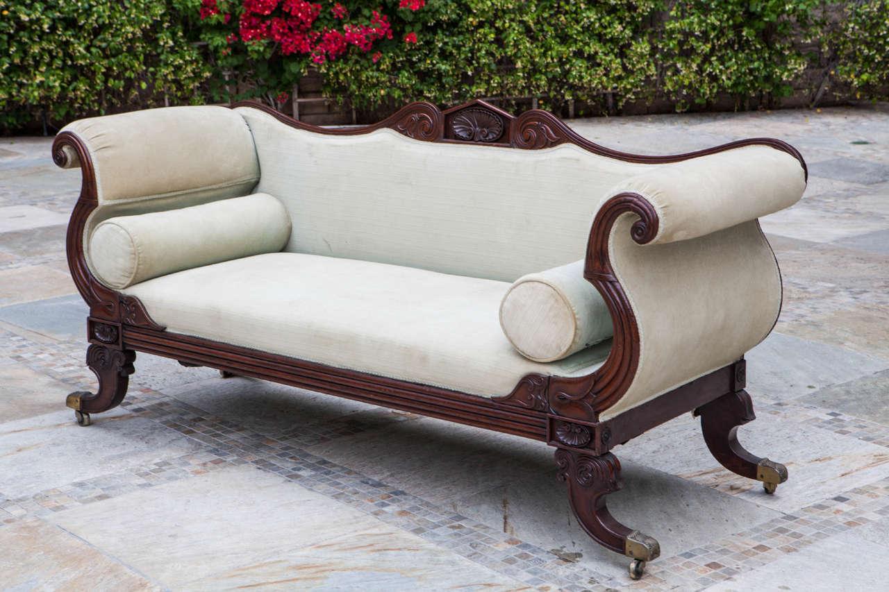 Mid-19th c. American Finely Carved Mahogany Settee with Shell Motif and original Brass Casters.