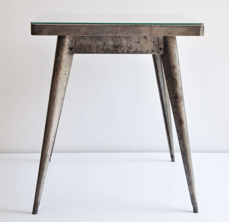 Industrial, metal table with splayed legs reminiscent of Jean Prouve, designed by Xavier Pauchard for Tolix, France. A dynamic, modernist design.  Very sturdy construction.