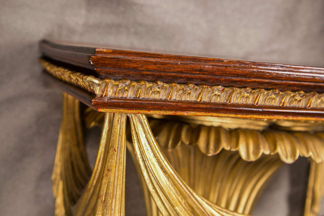 Pair of charming neoclassical style wall brackets, the mahogany shelf supported by painted and parcel-gilt fluted urn-form base, decorated with drapery elements.