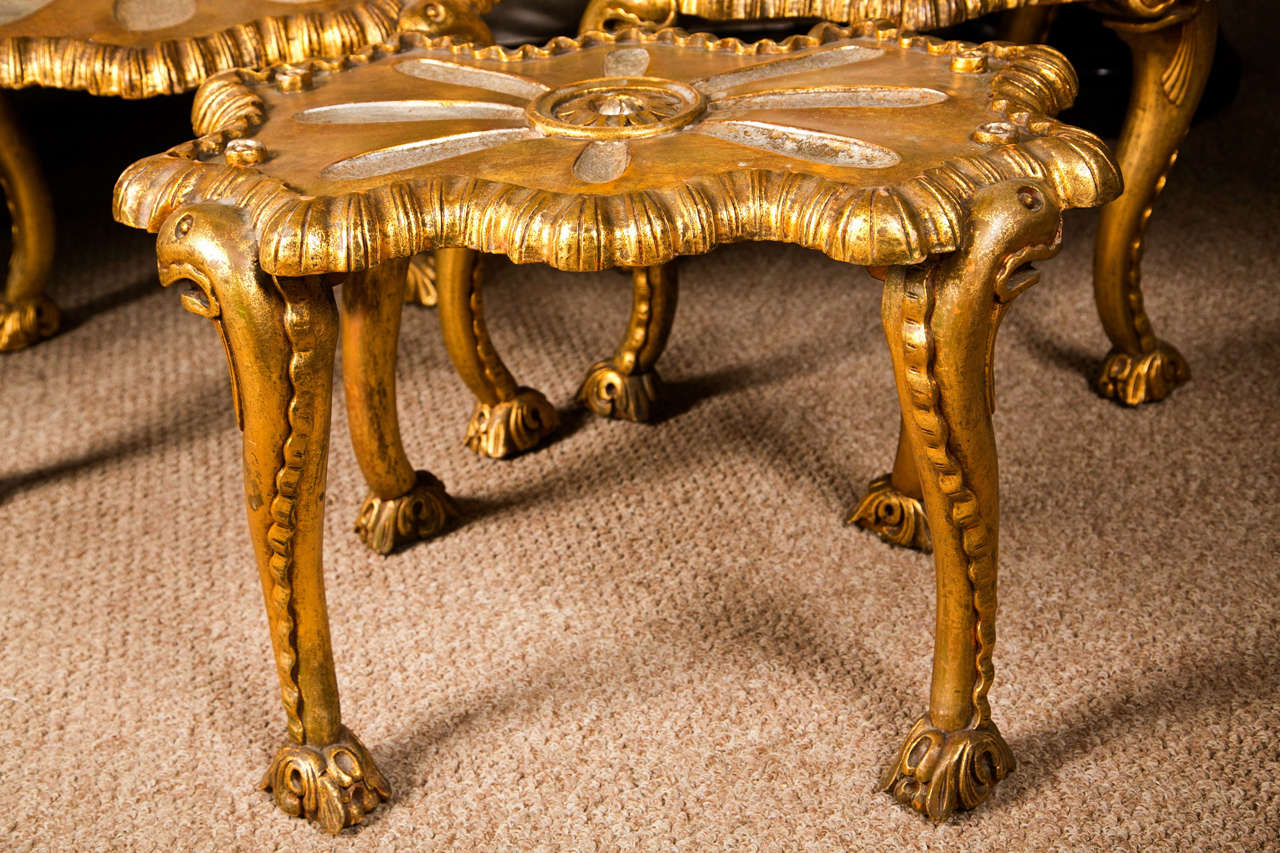Pair of spectacular French Rococo style armchairs and matching stool, in distressed gold and silver gilt, the shell-form back-splat joint with scrolled arms and scalloped seat, raised on cabriole legs; the stool in the similar taste decorated with a