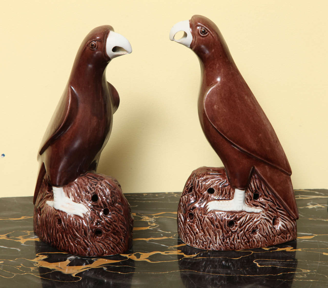 Fine pair of Chinese export porcelain parrots with a brown enamel glaze and non-glazed white biscuit beaks and talons, circa 1850.