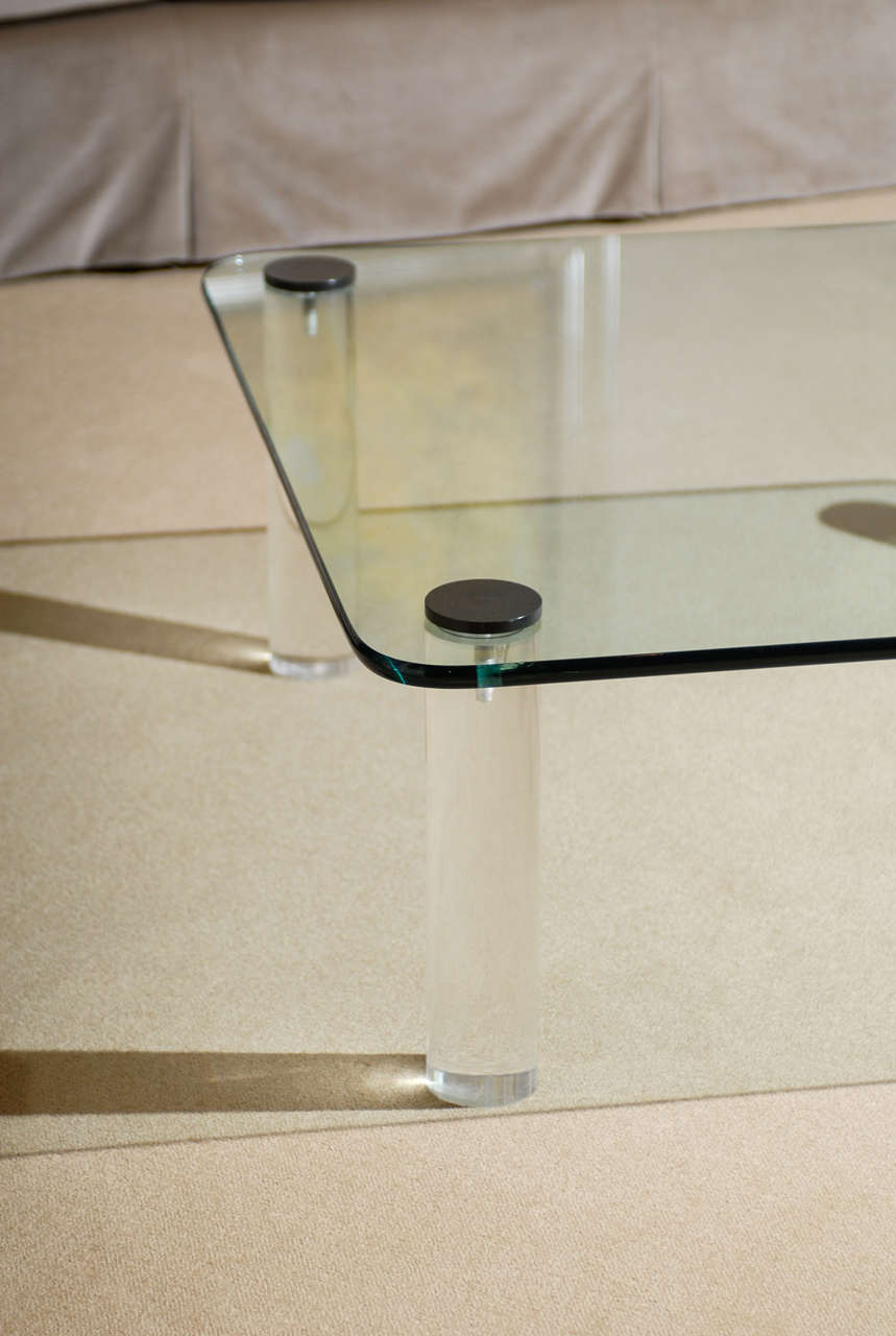 A beautiful coffee table by Pace, circa 1975. Thick glass top with lucite legs and bronze detail.  Exquisite jewelry!  Excellent Vintage Condition. Glass is in excellent condition and the lucite legs are clear.