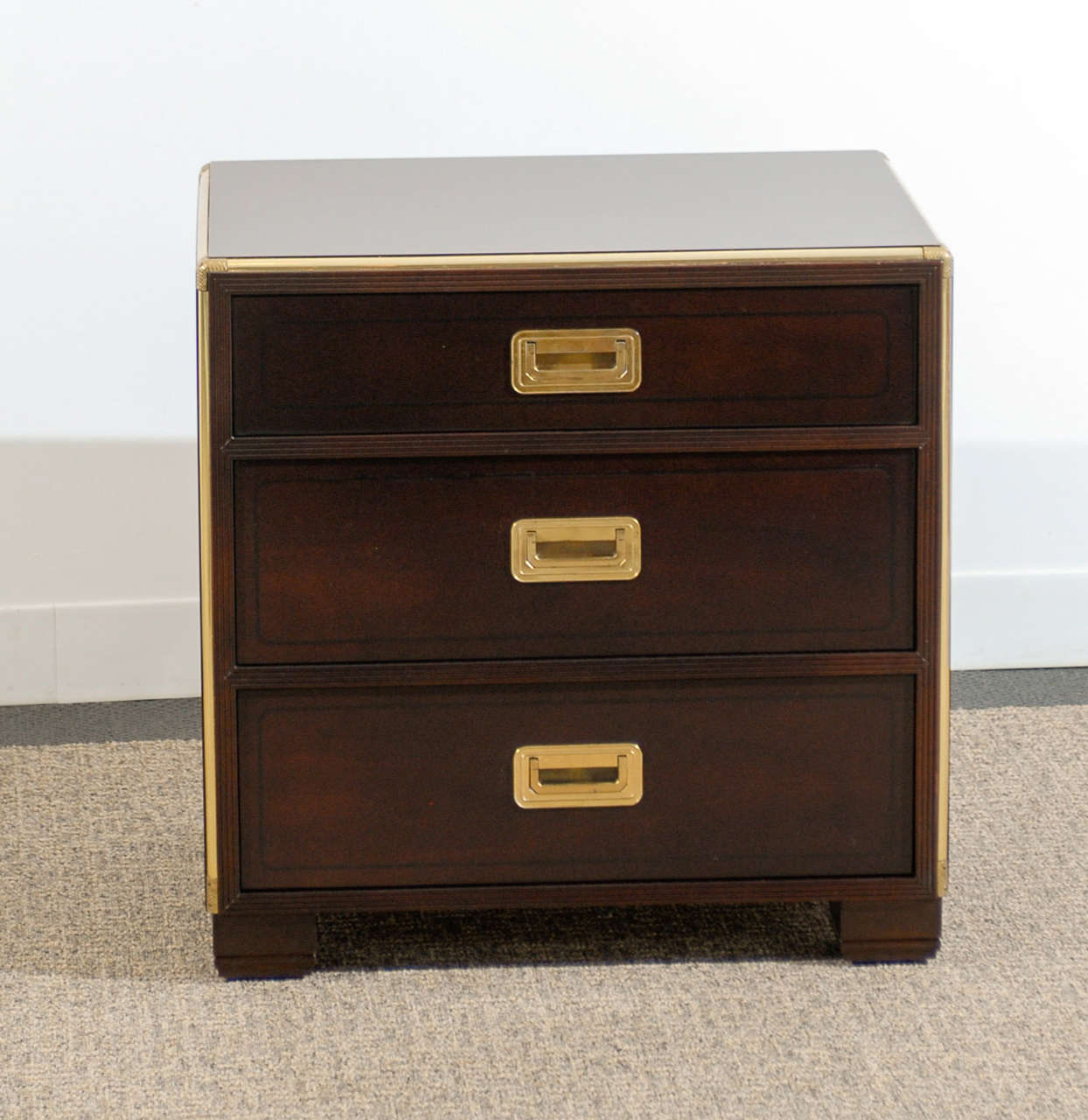 A beautiful and functional pair of three (3) drawer campaign chests by Baker,Circa 1970. Can be used as end tables or nightstands. Handsome solid brass detail. Restored in espresso lacquer. Retains the maker tag. Excellent Restored Condition. The