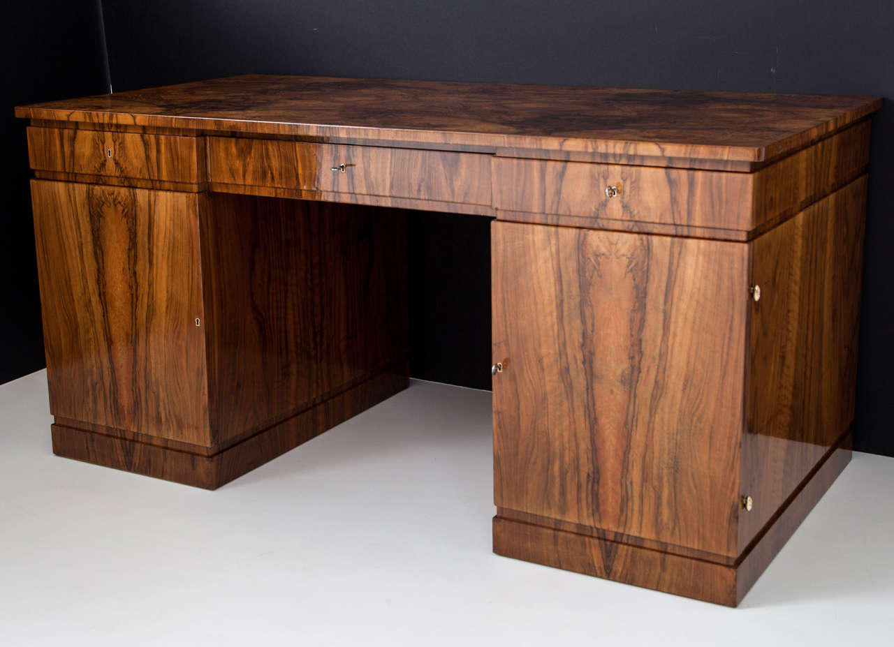 A very rare Danish Caucasian black walnut pedestal desk designed by Kay Gottlob and produced by A.J Iversen cabinetmaking establishment, Copenhagen, Circa 1930, with a extremely figured bookmatched rectangular top above three frieze drawers with two